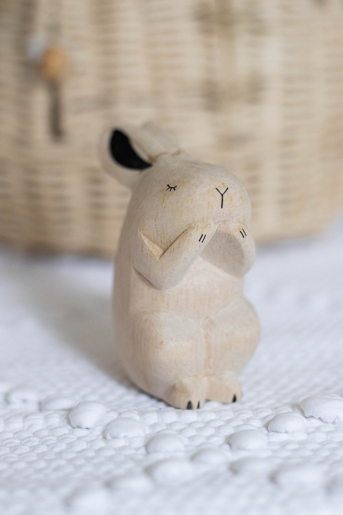 Wooden Child Rabbit figurine in a lifestyle setting